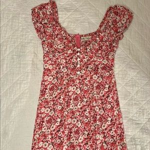 Sunday Muse puff sleeve floral sun dress with leg slit. Button front detail.